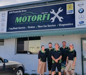 The dedicated Motorfix team standing proudly outside their Wangara workshop, showcasing services including brake repairs.